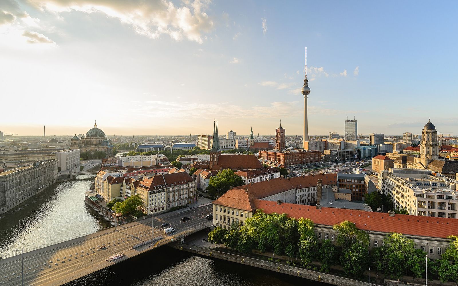 Blick von der Fischerinsel über die Spree auf Berlin-Mitte mit Fernsehturm, Berliner Dom, Nikolaikirche und Rotem Rathaus in warmem Sonnenlicht