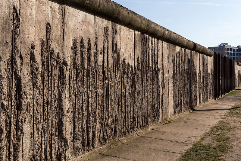 Erhaltenes Teilstück der Berliner Mauer an der Bernauer Straße, die Betonoberfläche ist von abgeschlagenen Stücken zerfurcht